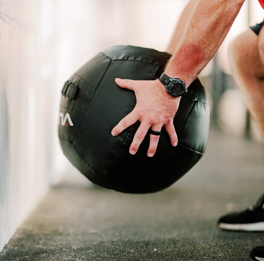Home 2 man training with a wall ball at the gym